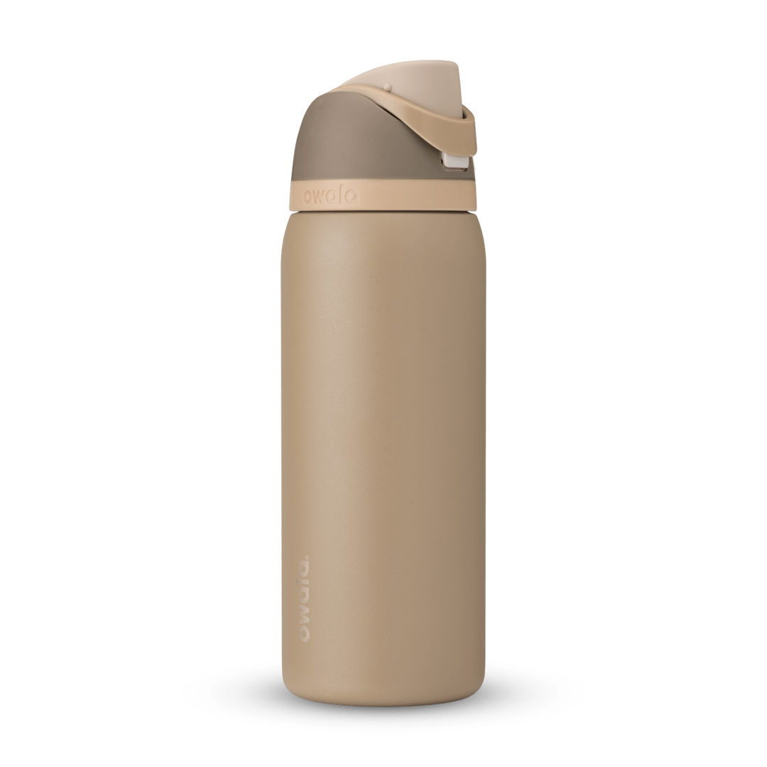 Full profile shot of the 32oz Down to Earth FreeSip water bottle in tan, highlighting its tan and silt colors.